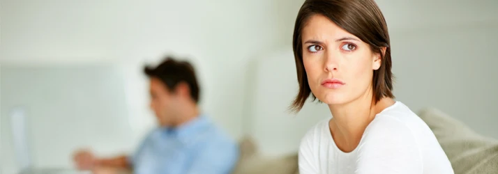 Chiropractic Littleton CO Woman Sits On Couch Concerned about Bladder Health Woman Sits On Couch Concerned about Bladder Health