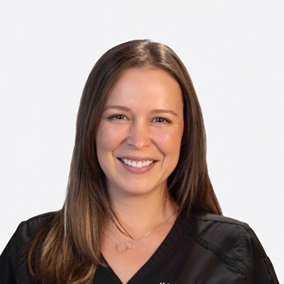 Adult Gerontology Nurse Practitioner Kristine Benson Smiling In Scrubs